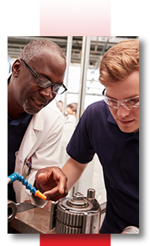 Mentor and student working on a piece of machinery.